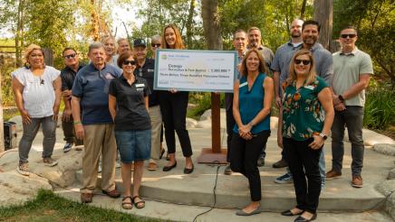 Group photo with large check