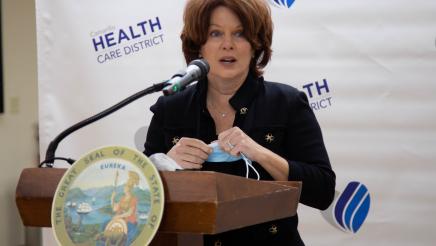 Woman at podium, speaking