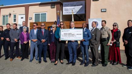 Group photo with large check