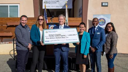 Group photo with large check