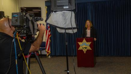 Asm. Irwin at podium, speaking while on camera