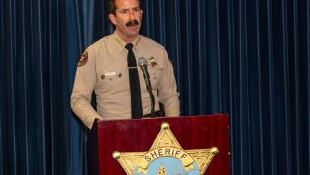 County Sheriff Bill Ayub at podium, speaking