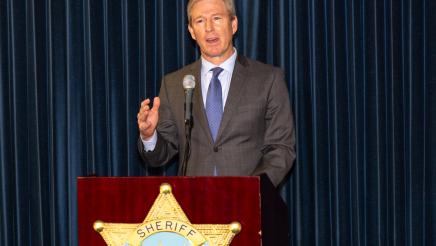 Ventura County District Attorney Erik Nasarenko at podium, speaking