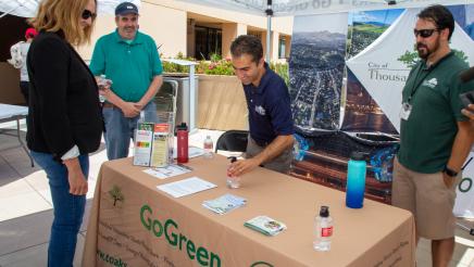 Asm. Irwin speaking with staffers of the City of Thousand Oaks' GoGreen booth