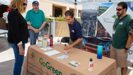 Asm. Irwin speaking with staffers of the City of Thousand Oaks' GoGreen booth