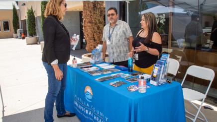 Asm. Irwin speaking with staffers of the Ventura County Behavioral Health booth