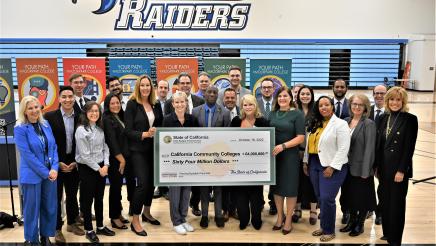 Group photo with large ceremonial check