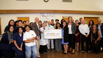 Group photo with large check held at center