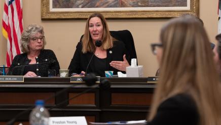 Asm. Irwin speaking as guest listens on in foreground
