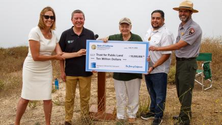 Asm. Irwin and others holding large ceremonial check