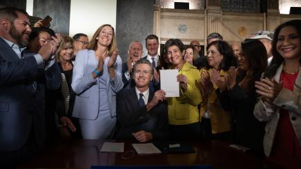 Governor Newsom after signing AB 531, Asm Irwin & SB 326 Sen Eggman with others in background