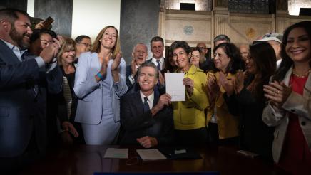 Governor Newsom after signing AB 531, Asm Irwin & SB 326 Sen Eggman with others in background