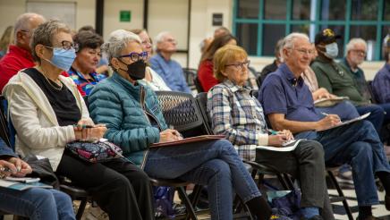 Audience members listening attentively