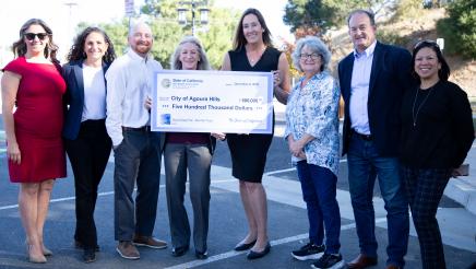 Asm. Irwin with city officials, holding large ceremonial check
