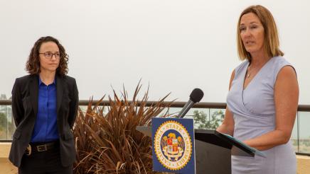 Honoree listens on as Asm. Irwin speaks at podium
