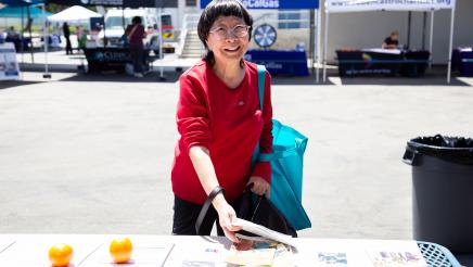 Constituent collecting informational materials from table