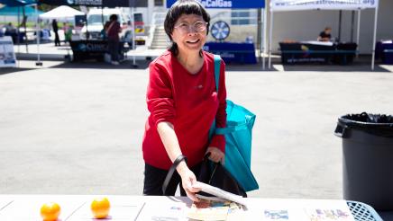 Constituent collecting informational materials from table