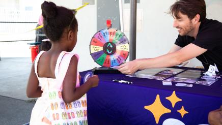 Table staffer handing prize to child
