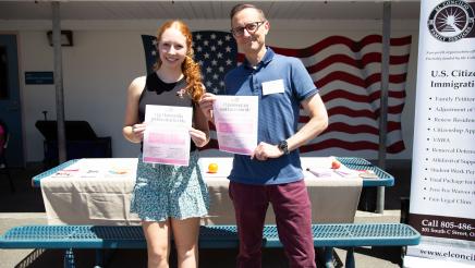 Conejo Free Clinic staffers holding up informational sheets