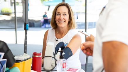 Asm. Irwin receiving blood pressure test at table