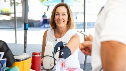 Asm. Irwin receiving blood pressure test at table