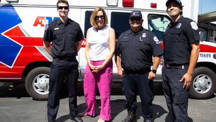 Asm. Irwin posing with paramedics in front of ambulance