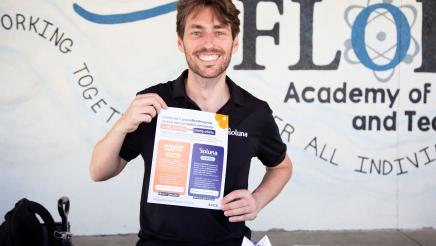 Soluna table staffer holding up informational sheet