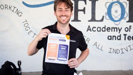 Soluna table staffer holding up informational sheet