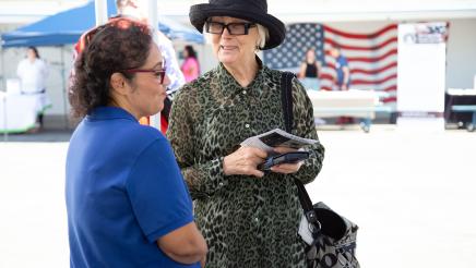 Constituent conversing with table staffer