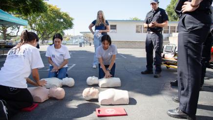 Attendees being given CPR lessons