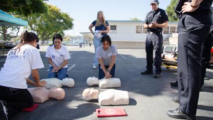 Attendees being given CPR lessons