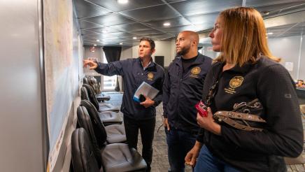 Asm. Irwin, Asm. Bryan and Asm. Gabriel observing map of fire area