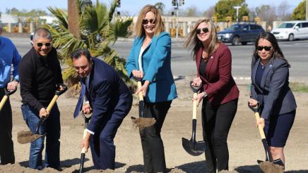 Asm. Irwin and other officials scooping up dirt with shovels 