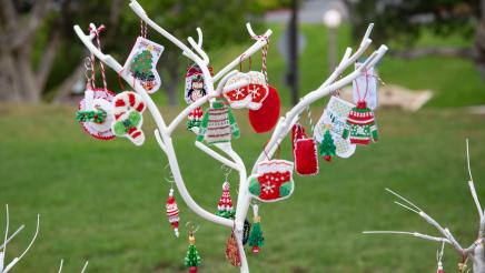 Small white tree with hanging Christmas ornaments