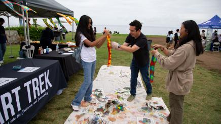 Art staffer assisting attendees with art projects