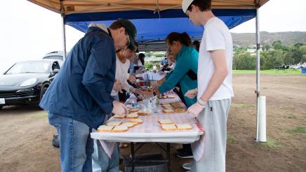 Volunteers making sandwiches at table